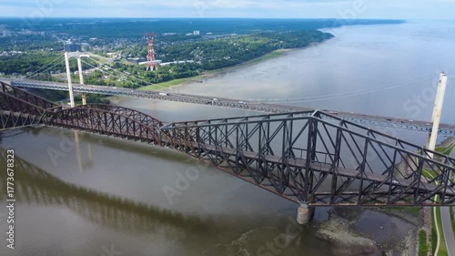 Bird's-eye view of two generations of bridges. The longest cantilever bridge in the world, the Quebec Bridge, and the Pierre-Laporte Suspension Bridge spanning the St. Lawrence River, Quebec, Canada.