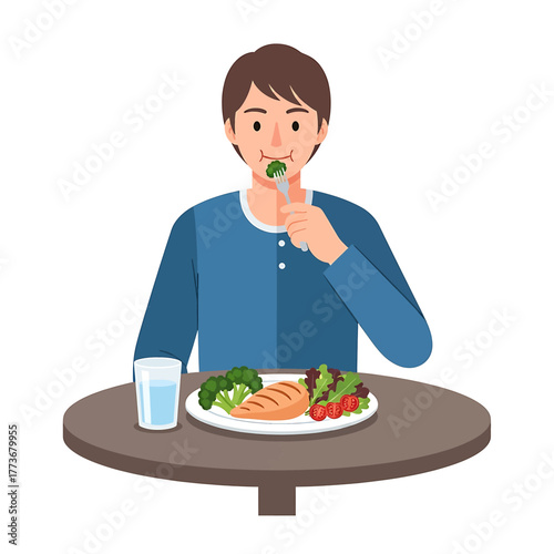 Man Eating Healthy Meal of Grilled Chicken, Broccoli, and Tomatoes at a Table