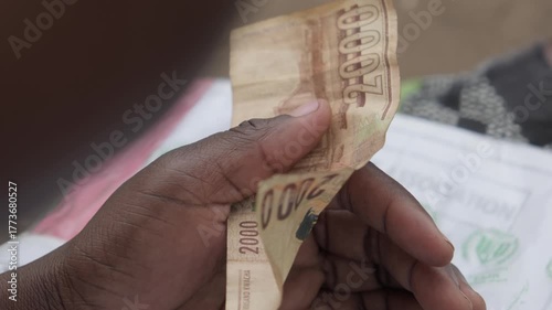 Someone holding Malawian money 