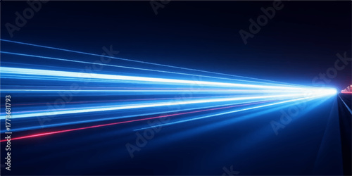 Futuristic abstract speed motion blur with blue and purple light lines forming an energy wave on a dark road background