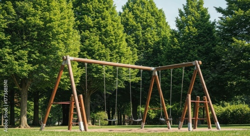 Wallpaper Mural Swing set in park, lush green trees, sunny day, empty playground Torontodigital.ca