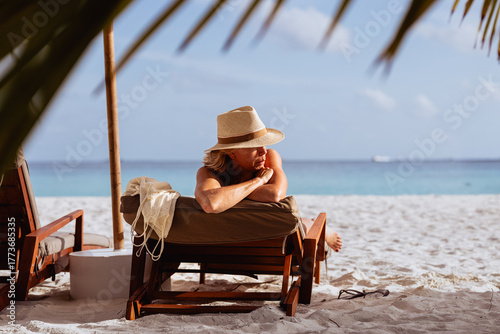 Mature beautiful Woman relaxing on beach lounge chair during vacation
