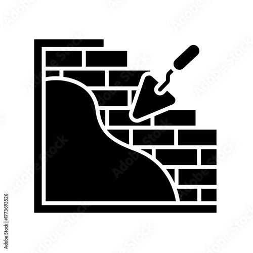 a construction worker is bricklaying a brick wall using a trowel for masonry and plastering architecture