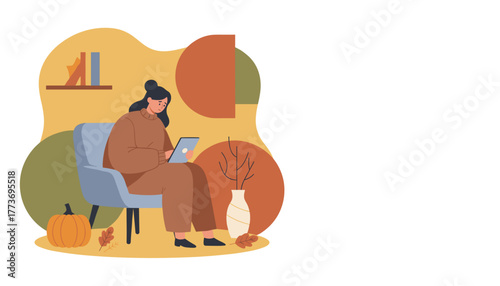 Cozy autumn scene Woman relaxing or working remotely on a tablet in a comfortable chair