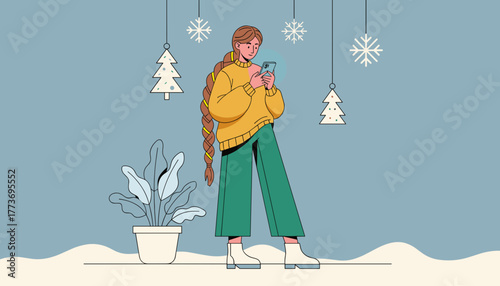 Young woman checks her phone indoors during the festive winter holiday season