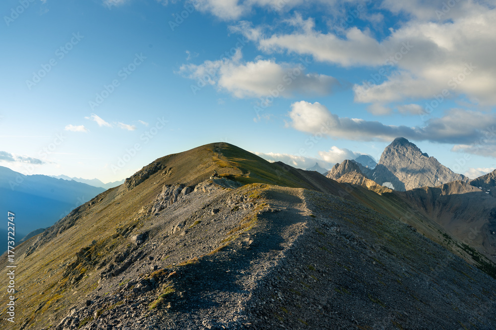 Fototapeta premium A winding trail snaking along the ridge line of a rugged, rocky mountain.