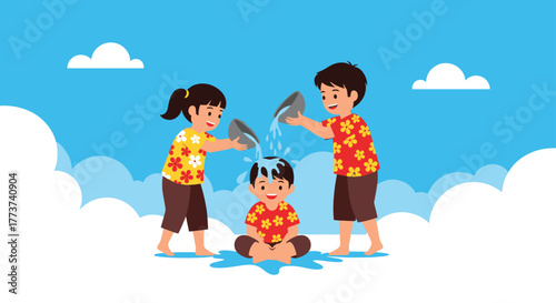 Two children playfully pour water on a third child sitting down, celebrating a water festival on a sunny day.