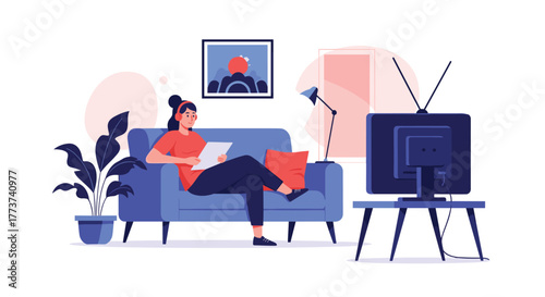 Young woman relaxing on a couch with headphones and tablet watching television in a living room.