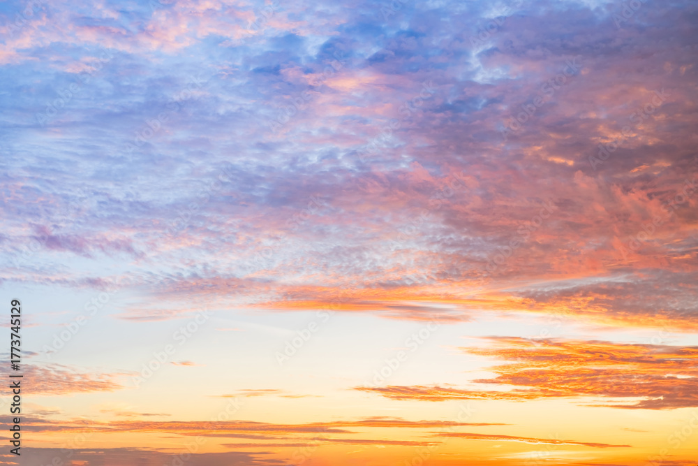 Obraz premium Sunset or sunrise sky with a vibrant gradient of orange, gold, and soft blue. Clear atmosphere with wispy clouds. Peaceful, natural light background. hope, freedom, new day and inspirational Concepts