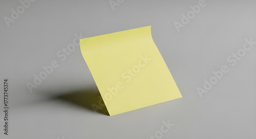A lone yellow sticky note, waiting for a thought. Cleanly cut out and placed against a simple backdrop, ready to be used in your next project.