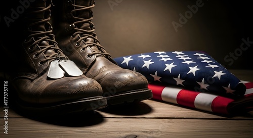 A pair of worn military combat boots with dog tags resting beside a folded American flag.
