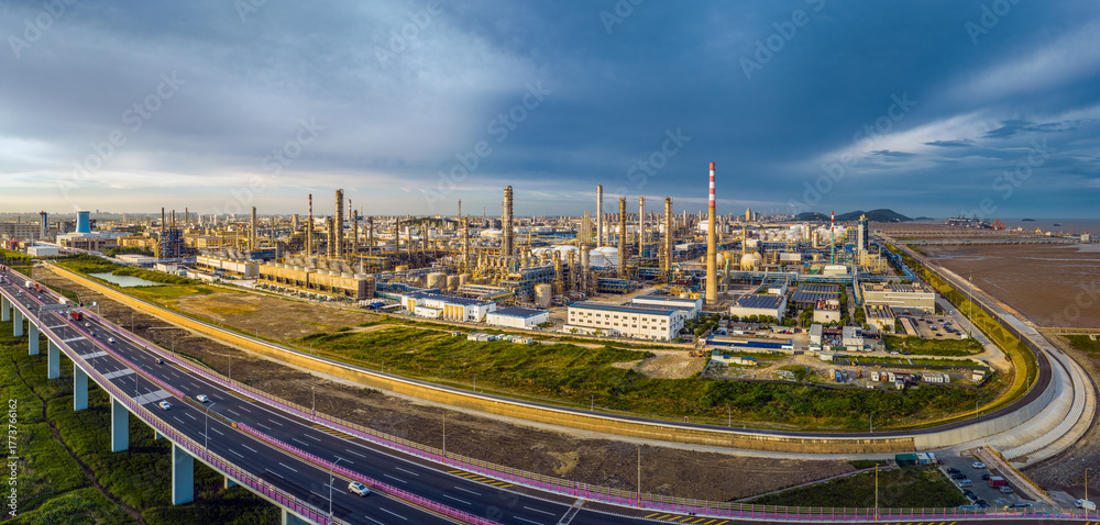 Fototapeta premium Panoramic view of a large oil refinery and chemical plant complex with a highway.