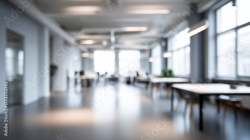 Wallpaper Mural A blurred view of a modern office space featuring tables, chairs, and large windows, creating a spacious and airy atmosphere. Torontodigital.ca