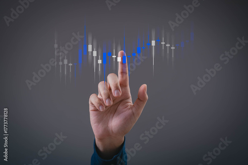Hand pointing at digital candlestick chart showing stock or cryptocurrency trading analysis with rising trend, representing investment, finance, and market technology concepts.