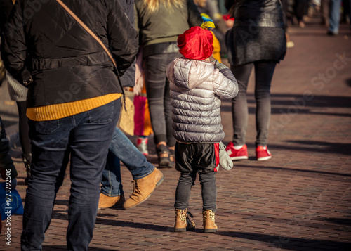 A young child dressed in costume waits excitedly for Saint Nicholas to arrive on his white horse, Amerigo, during the traditional Sinterklaas festivities in Dordrecht.