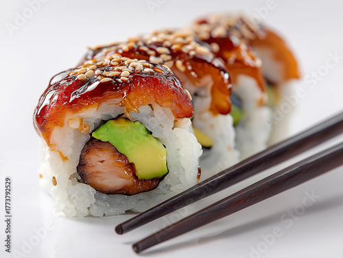 Dragon uramaki sushi roll with eel and avocado topping, studio macro photo