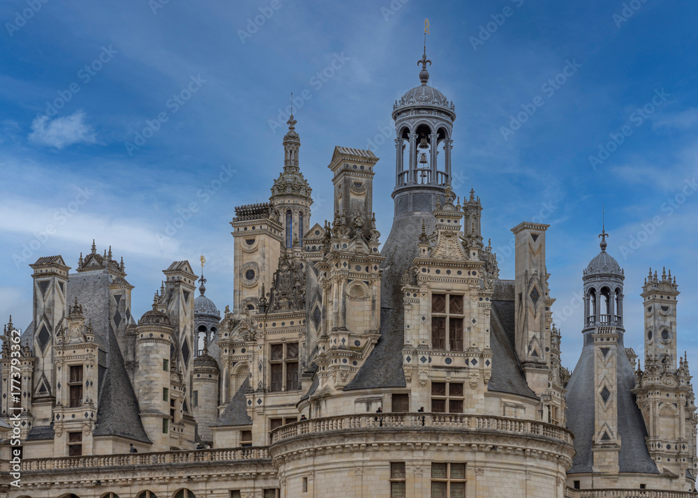 Naklejka premium Chambord, France - 10 27 2025: Detail view of the Chambord Castle roof with balconies, towers, bell towers and chimneys