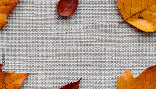 Autumn leave on woven tweed fabric copy space background