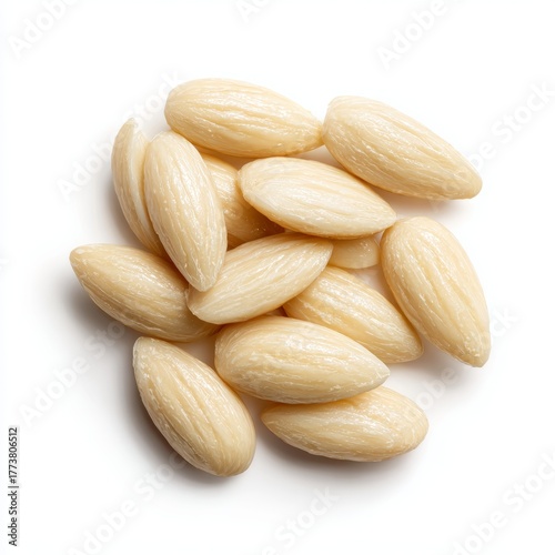 Close-up of a pile of blanched almonds, ready for culinary use. The nuts are smooth and creamy, a staple for healthy snacking or cooking