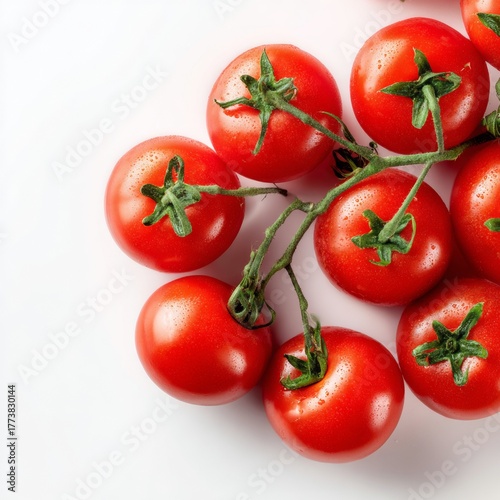 Vibrant red tomatoes on a green stem, perfectly ripe and ready to be enjoyed. These fresh tomatoes are a perfect addition to any meal.