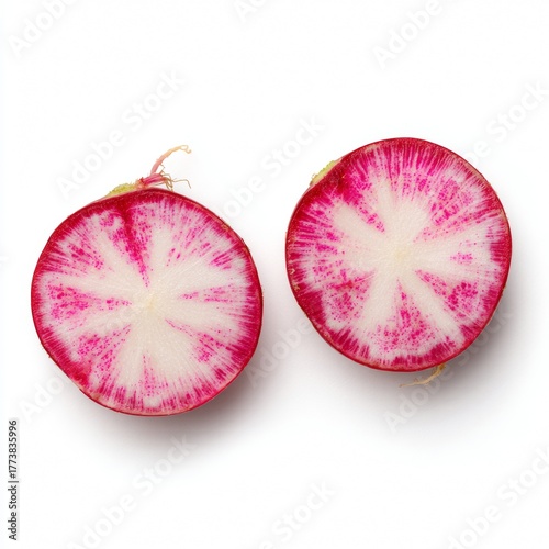 Two halves of a vibrant watermelon radish, cut to reveal their contrasting pink and white interior