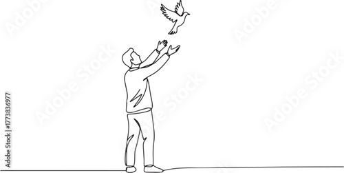 Simple continuous line drawing a man releasing bird into the air