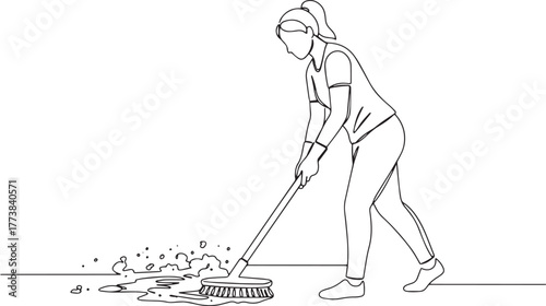 Woman performing cleaning tasks by scrubbing floor in continuous