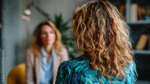 Unrecognizable female client in conversation with therapist in emotional support session