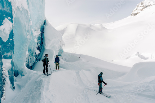 A group of skiers explore the large ice caves in the Northern Rockies of British Columbia, Canada.