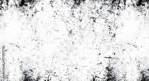 Abstract black and white grunge texture with scattered dark spots and scratches