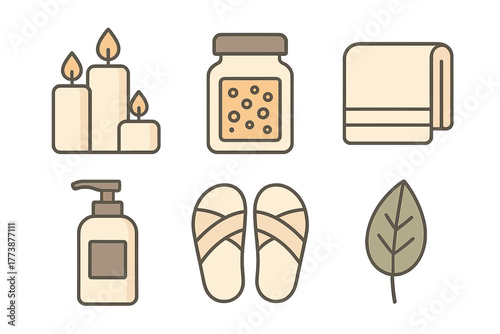 Spa and relaxation set with burning candles, folded towel, lotion bottle, and slippers