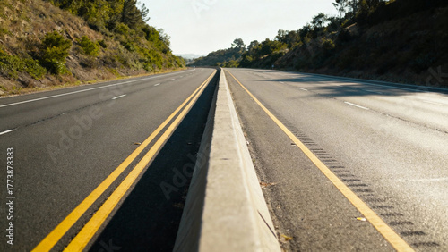Highway central divider with double yellow lines separating traffic lanes in daylight. mobility guides, transit brochures, designed for transport & logistics marketing.