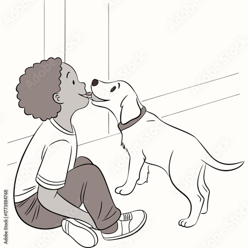 A happy young boy with curly hair is sitting on the floor and getting a kiss from his playful dog