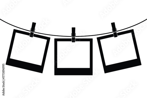 Three blank instant photo frames hanging on a clothesline