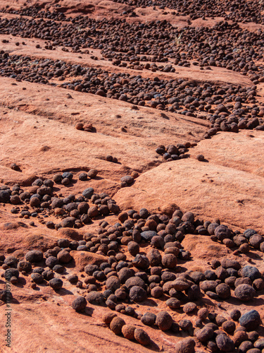 Iron Oxide Moqui marbles on red rock in Snow Canyon Utah