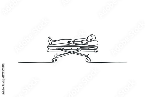 Person lying on a hospital stretcher with wheels