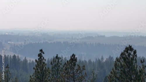 Drone flying right over hazy hills.