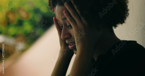 Photography Young boy in emotional breakdown, hands covering face, standing against wall, Af