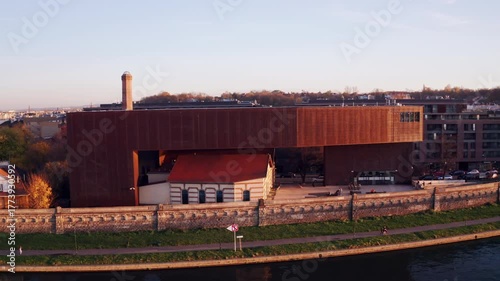 Striking riverside shot of Cricoteka’s contemporary museum building in Kraków, Poland, highlighting innovative architecture and the significance of urban cultural institutions.
