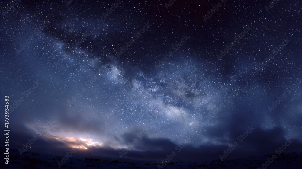 Obraz premium The majestic Milky Way galaxy arches across a dark starry sky over a serene twilight landscape