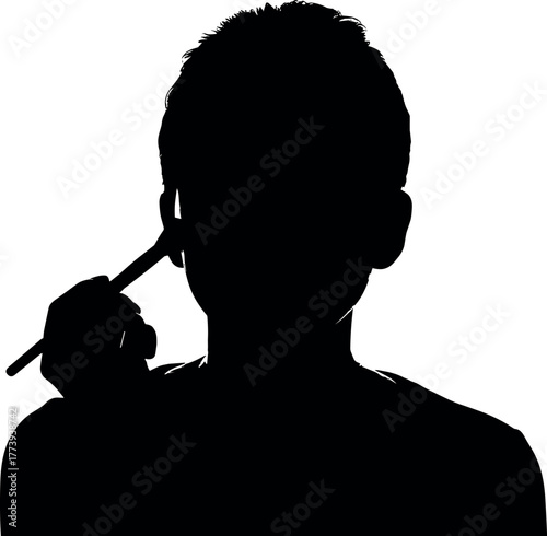 Silhouette of a Person Applying Makeup with a Brush for Beauty or Artistry