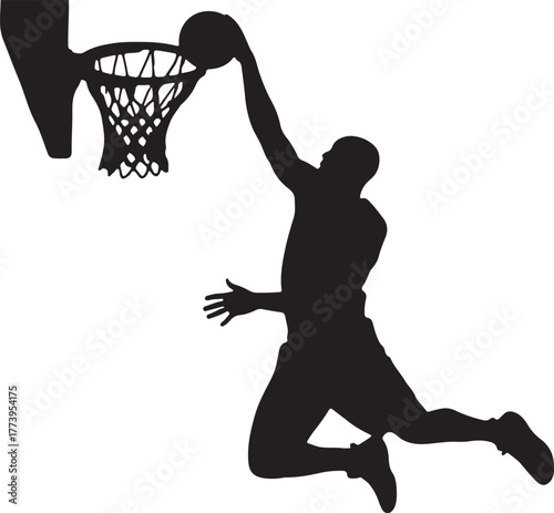 Silhouette of basketball player dunking the ball in a basketball hoop