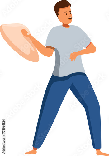 Young man having fun during a pillow fight, holding a pillow and smiling