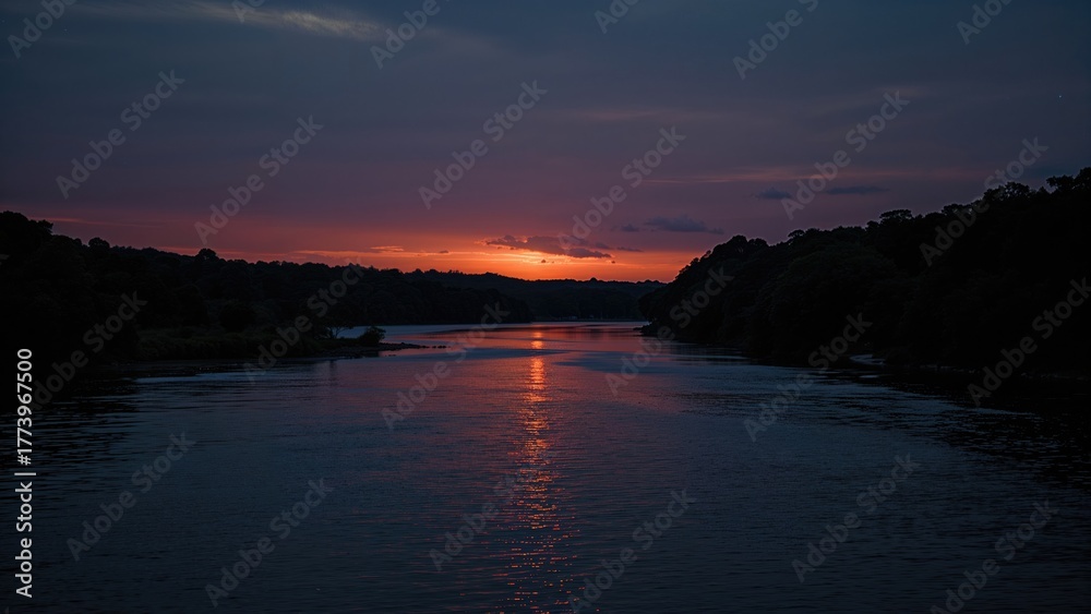 Fototapeta premium River at sunset during twilight with colorful sky and silhouetted trees. Nature landscape image. Tranquil water scene. Calm evening environment with peaceful surroundings.
