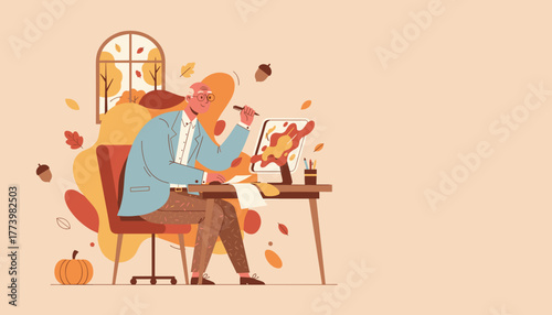 Senior creative man working on digital design at his home office desk during the autumn season