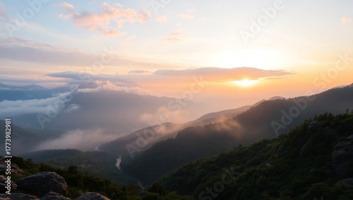 Fototapeta Naklejka Na Ścianę i Meble -  Golden sunrise over misty mountain valley, serene landscape beauty