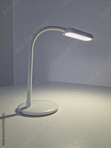 minimalistic white led lamp with button on the table
