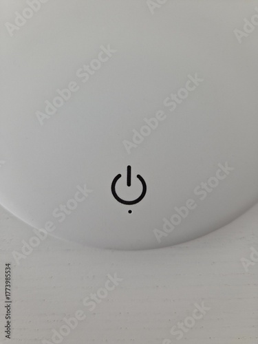 minimalistic white led lamp with button on the table