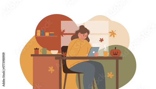 Sad woman uses tablet indoors in cozy autumn setting with pumpkin and leaves