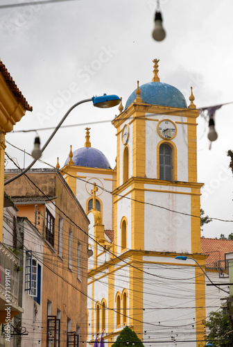 Historic Church of Nossa Senhora da Graça, one of the oldest in Santa Catarina, Brazil, seen between the narrow old streets of the São Francisco do Sul’s charming town